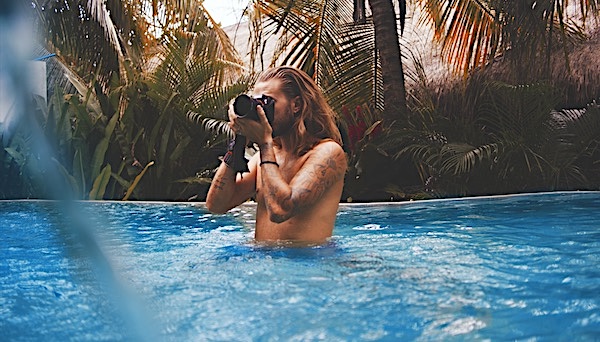 Man with long hair in a pool