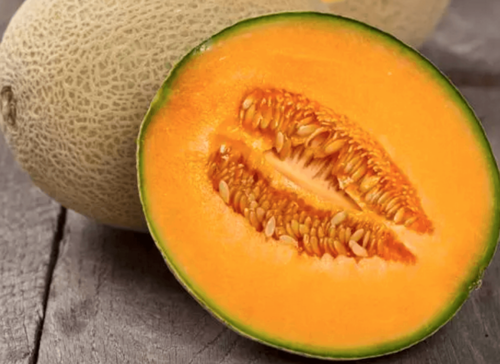 sliced cantaloupe on a wooden surface
