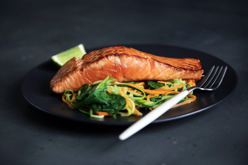 Plate with baked salmon and vegetables