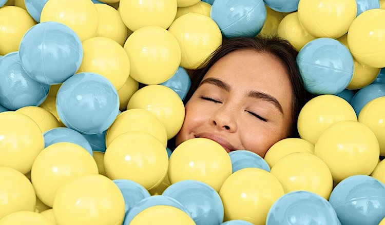 Women basking in a ball pit