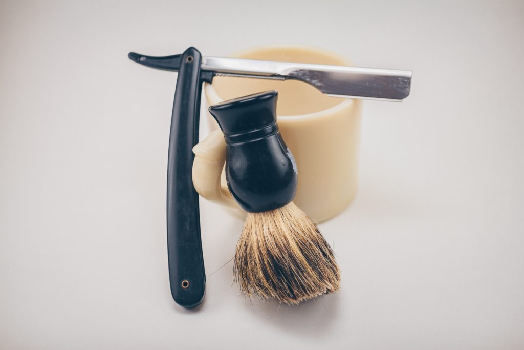 A straight edge razor, brush, and bowl