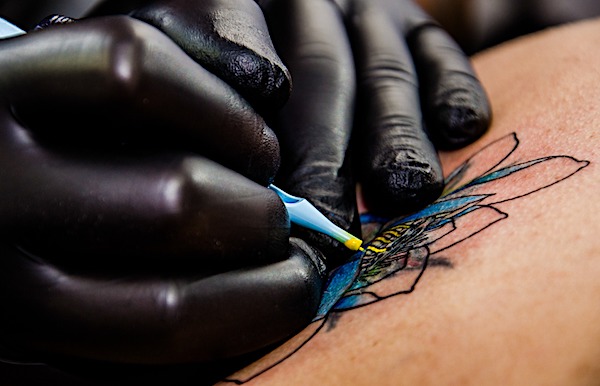 Up close photo of a colorful tattoo being worked on