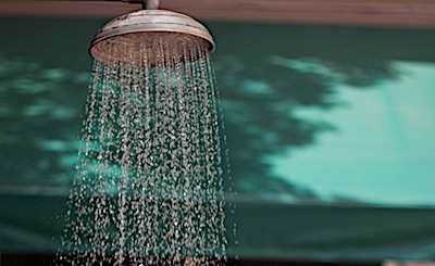 A shower head with water coming out.