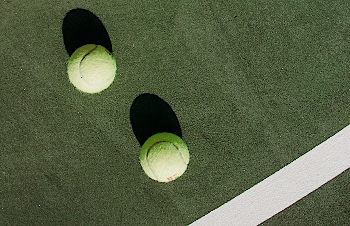 two tennis balls on a court