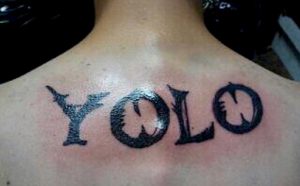 YOLO tattoo on a guys back