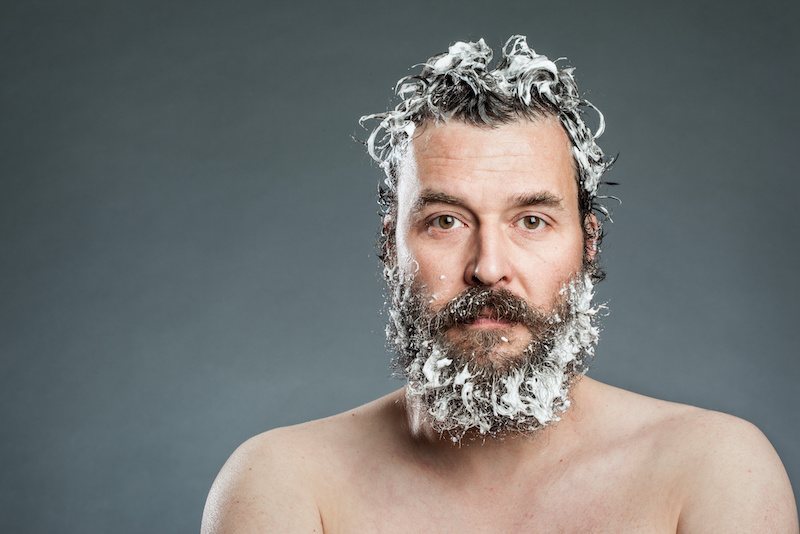 Man with soap suds in his beard