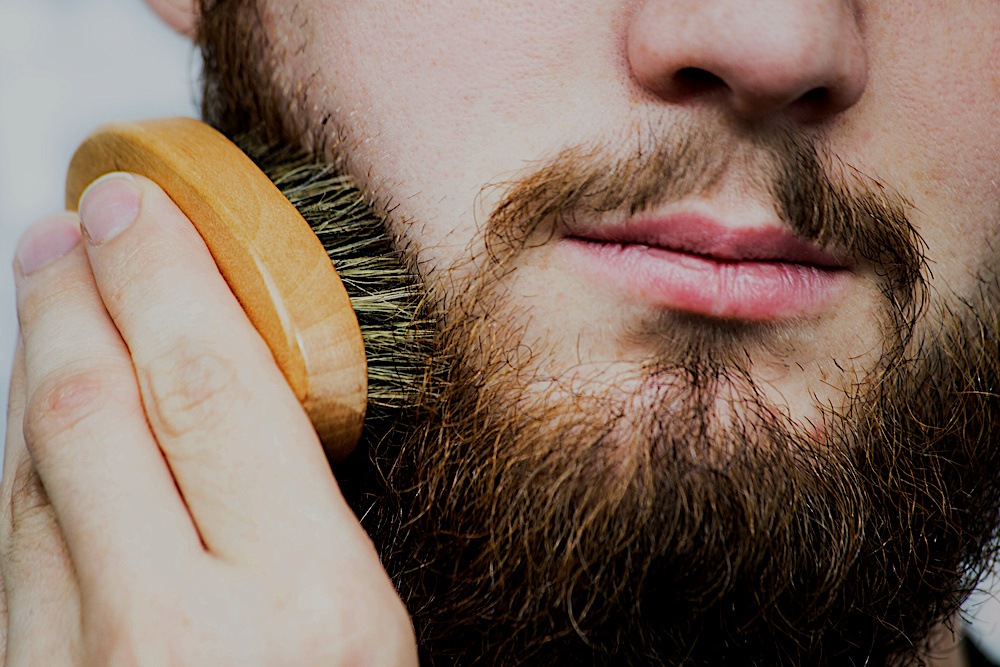 Man brushing his beard