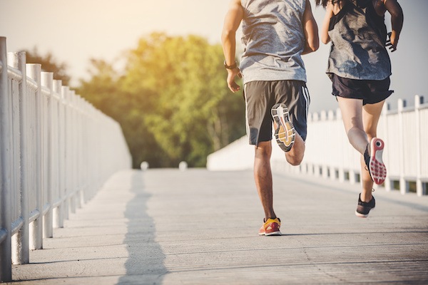 Man and a woman running in the park for exercise.