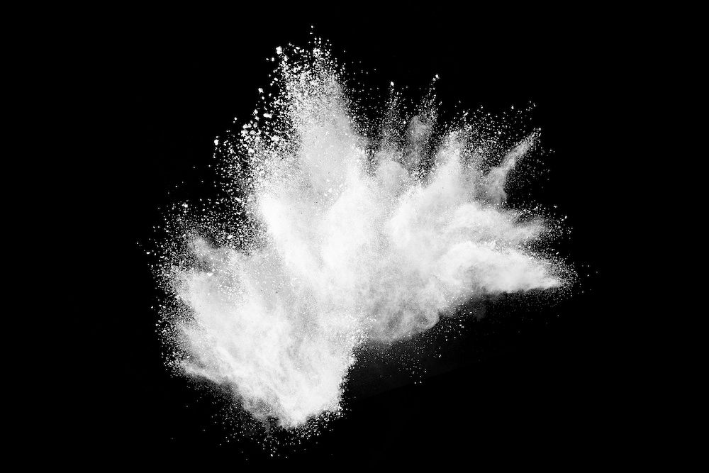 White powder explosion on black background.