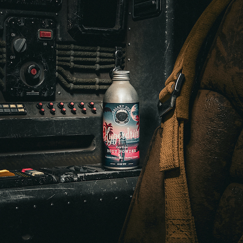 A bottle of Galaxy Dust body powder for men inside of a spaceship